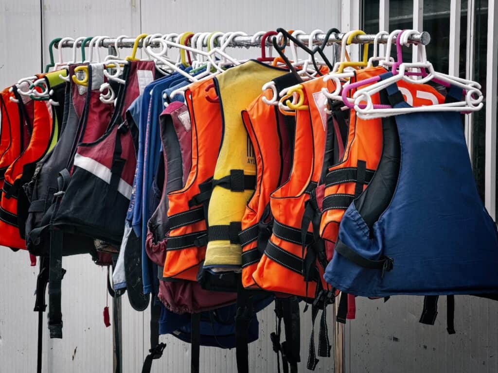 A rail with life jackets hanging on it