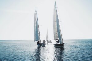 Sailboats sailing towards the horizon