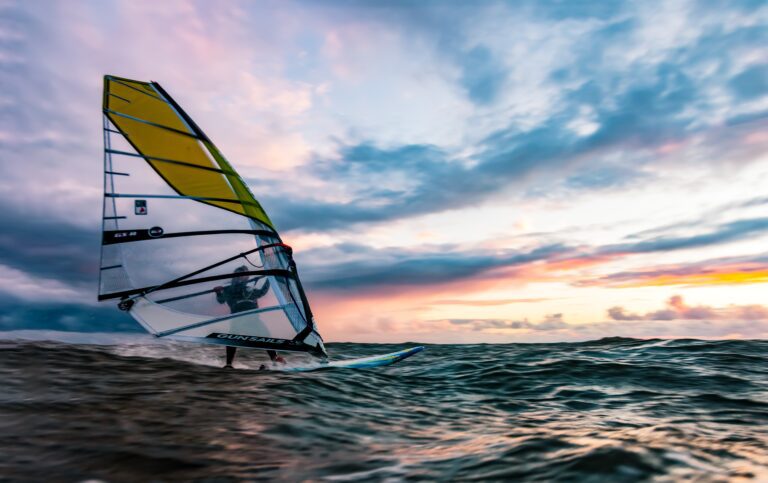 Windsurfing with a sunsetting in the background