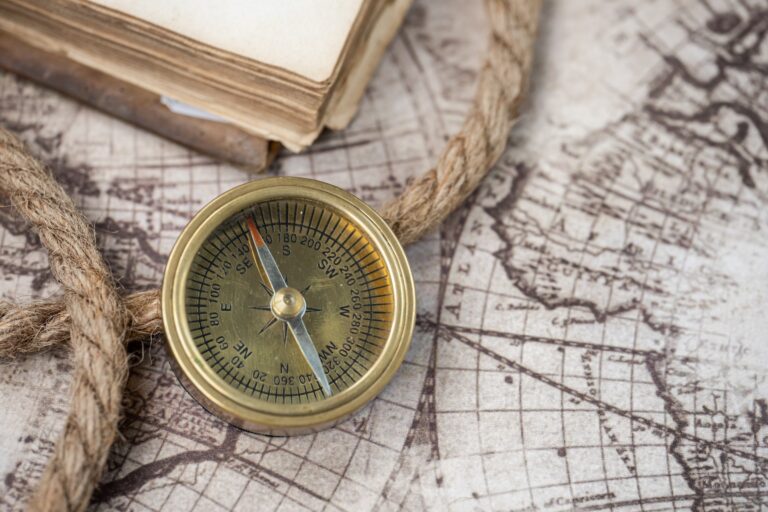 Sailing Navigation equipment, a compass sat on top of a rope and a map